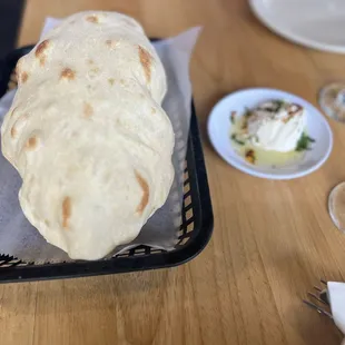 a plate of pita bread and a glass of wine