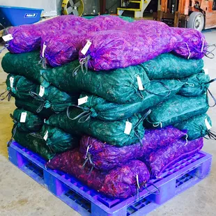 a stack of purple and green bags