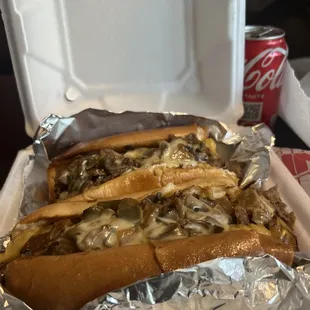 two hotdogs in a styrofoam container
