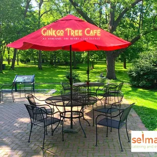 a patio with tables and umbrellas