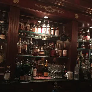 a bar with many bottles of alcohol
