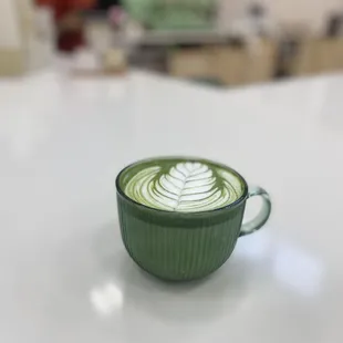 a green cup of coffee