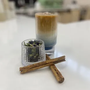 a cup of coffee and cinnamon sticks