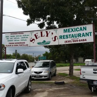 cars parked under a sign