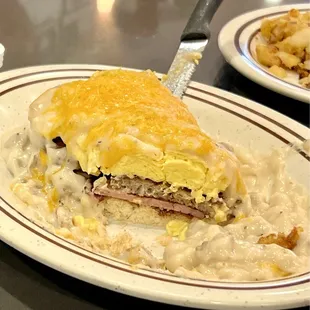 CowBoy : comes with biscuit, ham, sausage, bacon, topped with Country, gravy, and eggs! Incredible!