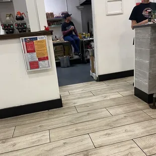 Cook sitting on the counter in kitchen right next to food prep area‼