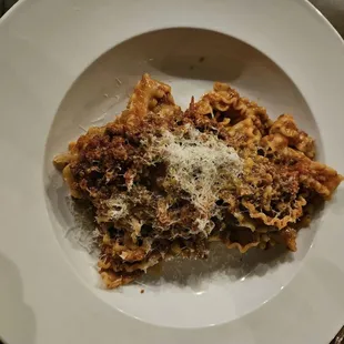 a plate of pasta with grated parmesan cheese