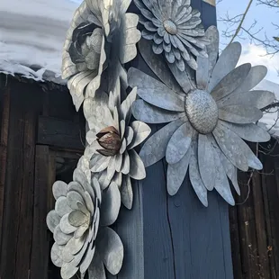 a closeup of metal flowers on a pole