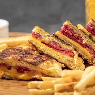 a grilled sandwich and french fries