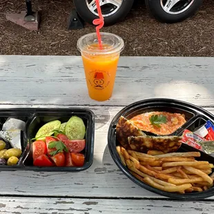 a sandwich and french fries on a picnic table