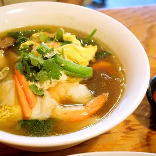 Suki Talay Noodle Soup: cod, shrimp, scallop, bean noodles, napa cabbage, Asian greens, carrots, celery, mushroom, egg in clear broth ($16).