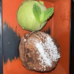 a green ice cream and a chocolate donut
