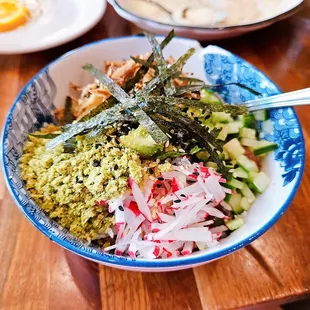 a bowl of food on a wooden table