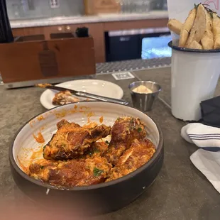 Chicken garlic Parmesan wings with duck fat fries.