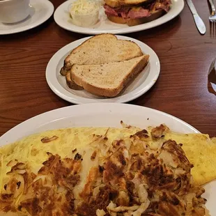 chili &amp; cheese omelet with hashbrowns and toast. Reuben in back