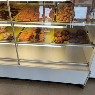 a variety of donuts in a display case