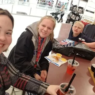 three girls sitting at a table