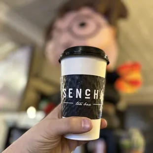 a hand holding a cup of coffee