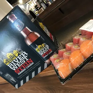 two boxes of beer and sushi