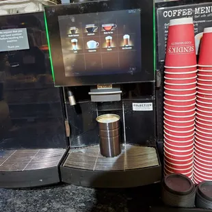 a coffee machine and cups