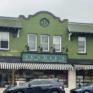 two cars parked in front of the store