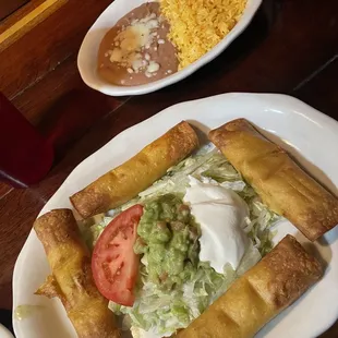 Chicken flautas  and rice and bean came with the Tacos Callegeros