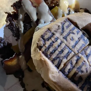 a grilled sandwich with meat and cheese