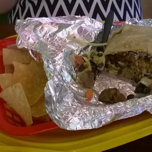 Beef fajita burrito with chips.