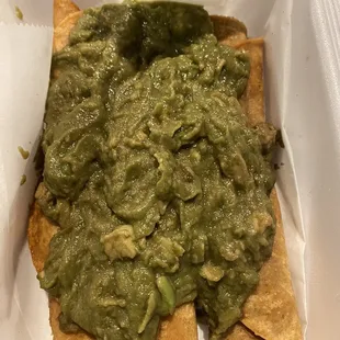 3 rolled tacos with BROWN guacamole