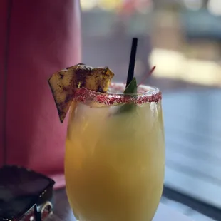 a drink with a pineapple garnish