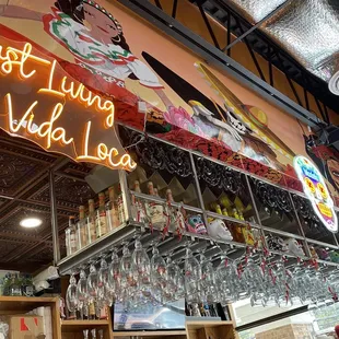 a neon sign above a bar