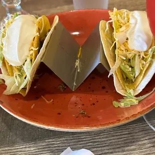 two tacos on a red plate