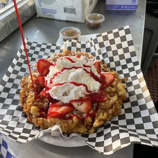 strawberries and whipped cream on a waffle