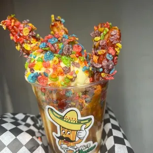 an ice cream sundae topped with fruity pebbles