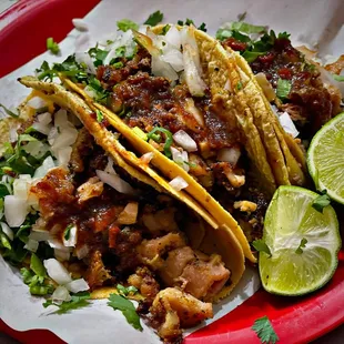 three tacos on a red plate