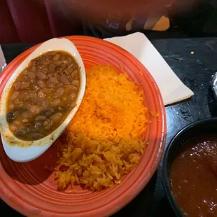 a plate of beans, rice, and a bowl of chili