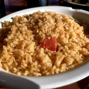 a plate of rice and tomatoes
