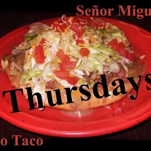 a red plate with a taco on it