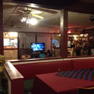 a red booth with a television in the background
