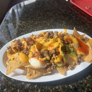 Carne asada nachos only carne, melted cheese sour cream and guacamole