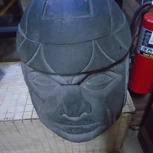 A giant Aztec style head by the front door.