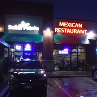 Outside of the restaurant on a rainy spring night, view looking south.