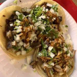two tacos on a paper plate