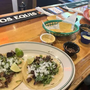 Carnitas and carne asada tacos. Salsas.