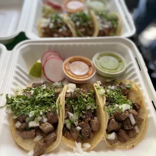 three tacos in a styrofoam container