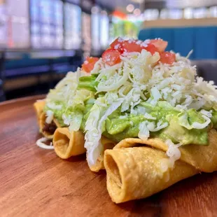 Rolled tacos  with guacamole, lettuce and cheese!!!