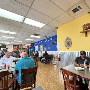 people sitting at tables in a restaurant