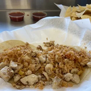 a chicken and rice taco with tortillas