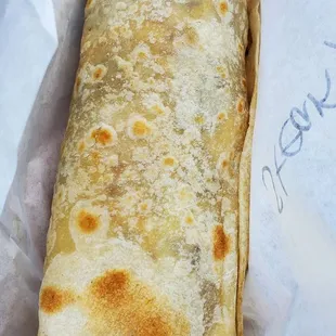 a burrito wrapped in wax paper