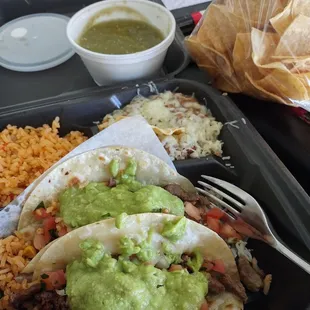 #6 2 taco combo carne asada tacos plus a bag of chips and green salsa.